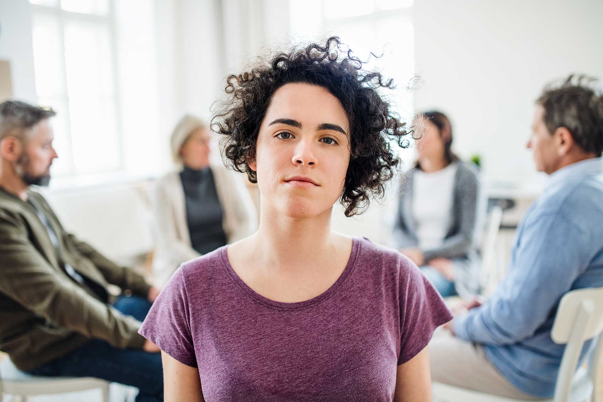 a-portrait-of-young-depressed-woman-during-group-t-YKGB2PX