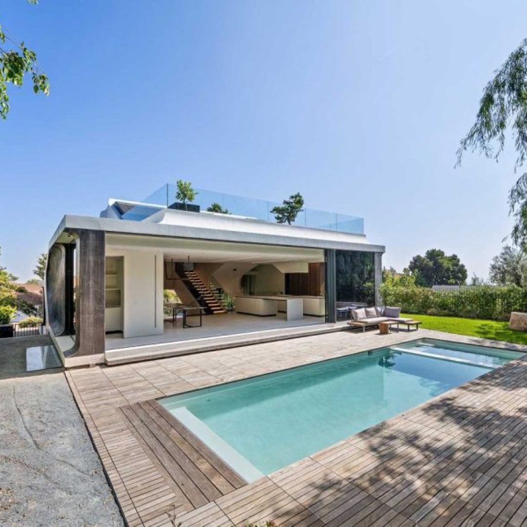 an-open-swimming-pool-is-in-the-backyard-of-a-home-SRNTQ4N