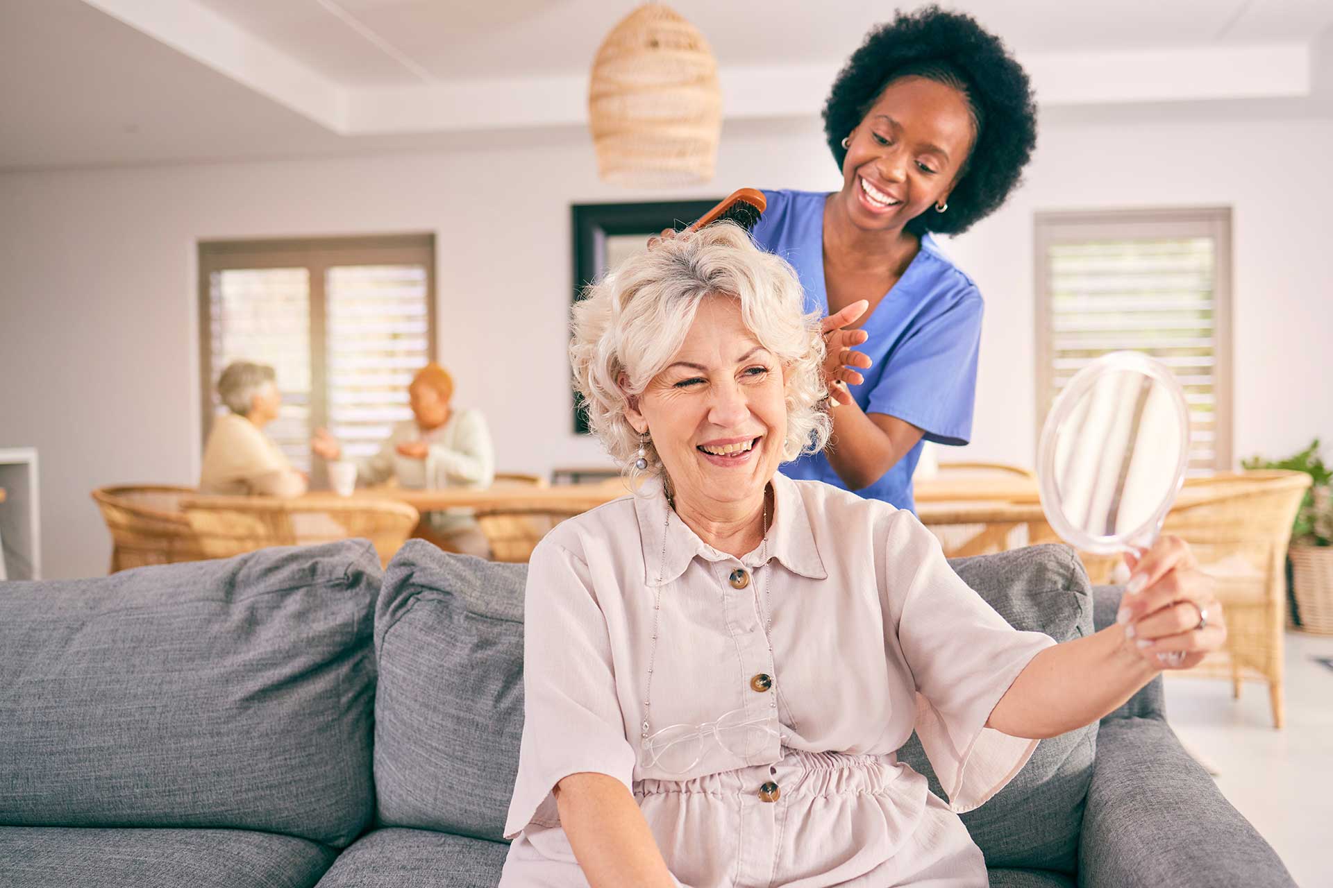 nurse-brush-hair-of-happy-mature-woman-in-the-livi-JAQXGJS